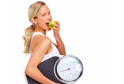 10-habits-that-can-help-you-lose-weight-s1-photo-of-woman-eating-apple-and-holding-scale