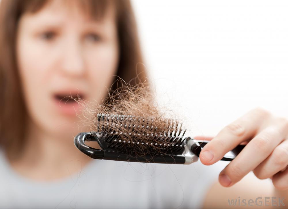 woman-with-hair-loss-looking-at-brush